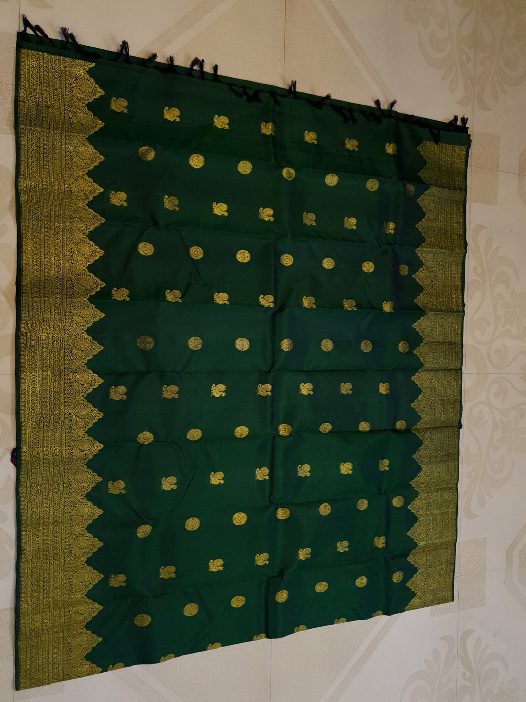 Bottle Green Kanchipuram handloom pattu silk saree featuring 2G gold zari motifs, a rich traditional border, and Silk Mark certification.
