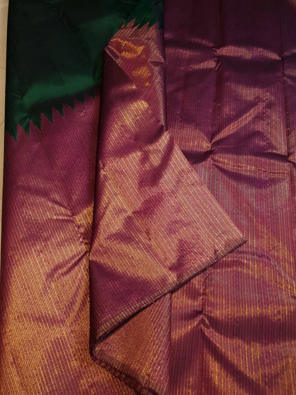 Bottle Green Kanchipuram handloom 2G gold temple silk saree featuring traditional gold zari weaving and classic temple borders.