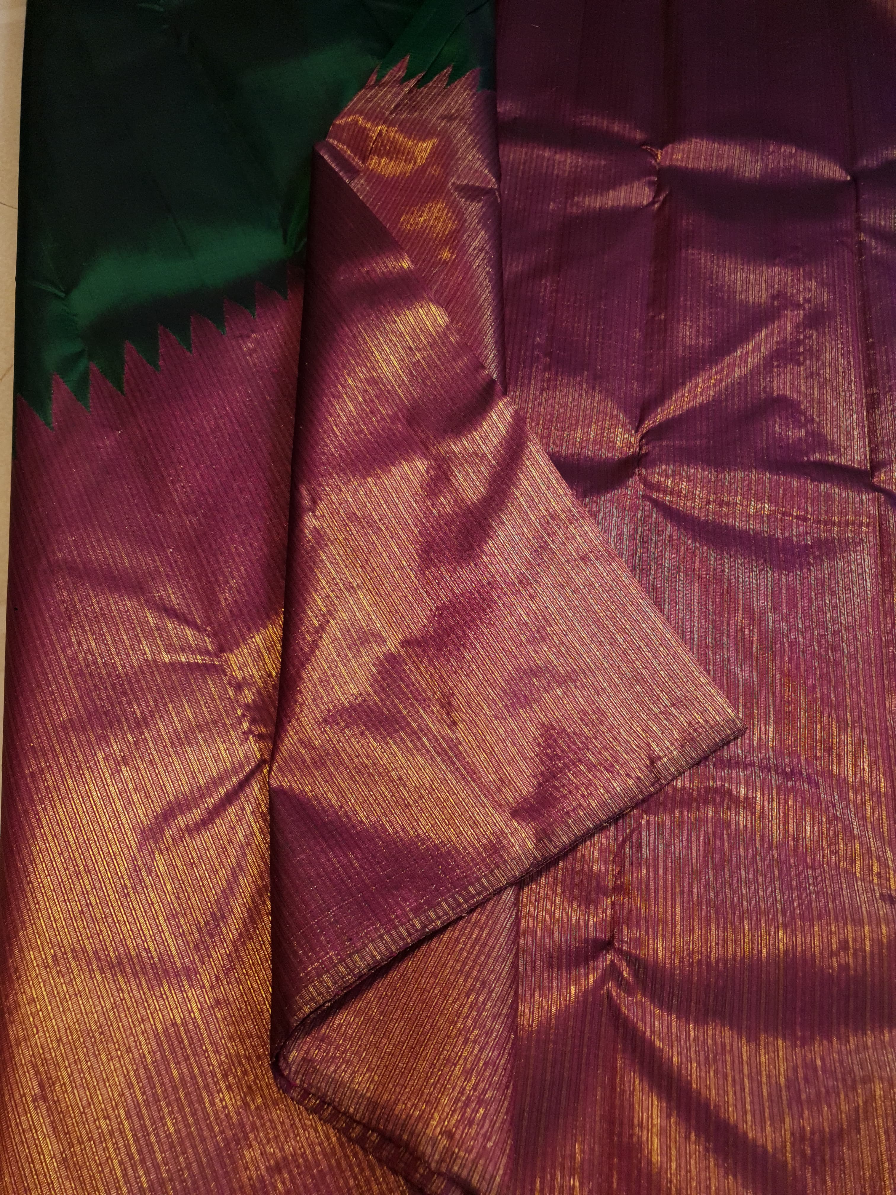 Bottle Green Kanchipuram handloom 2G gold temple silk saree featuring traditional gold zari weaving and classic temple borders.