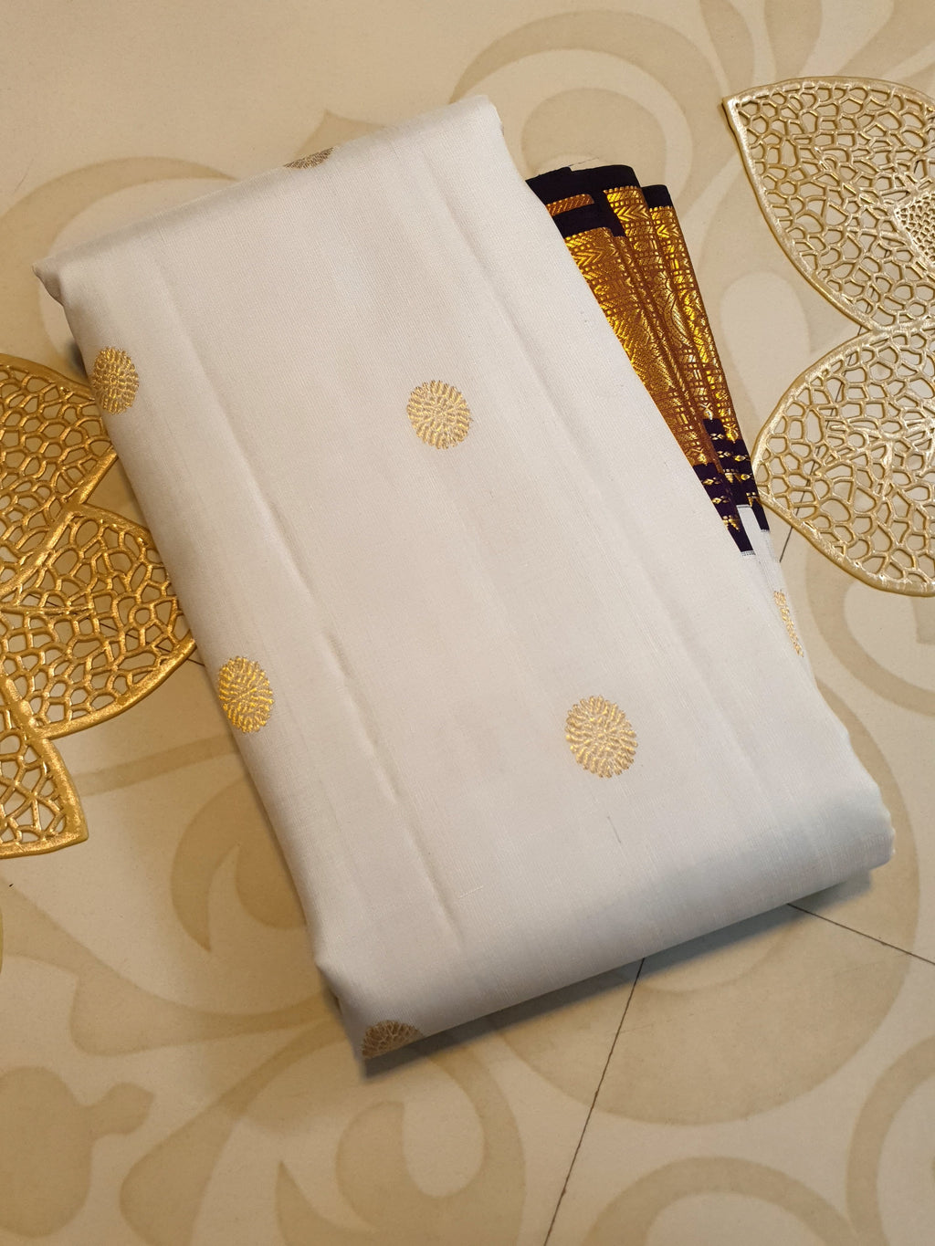 Cream Kanchipuram handloom 2G gold korvai silk saree showcasing a rich dark border and intricate gold zari motifs.