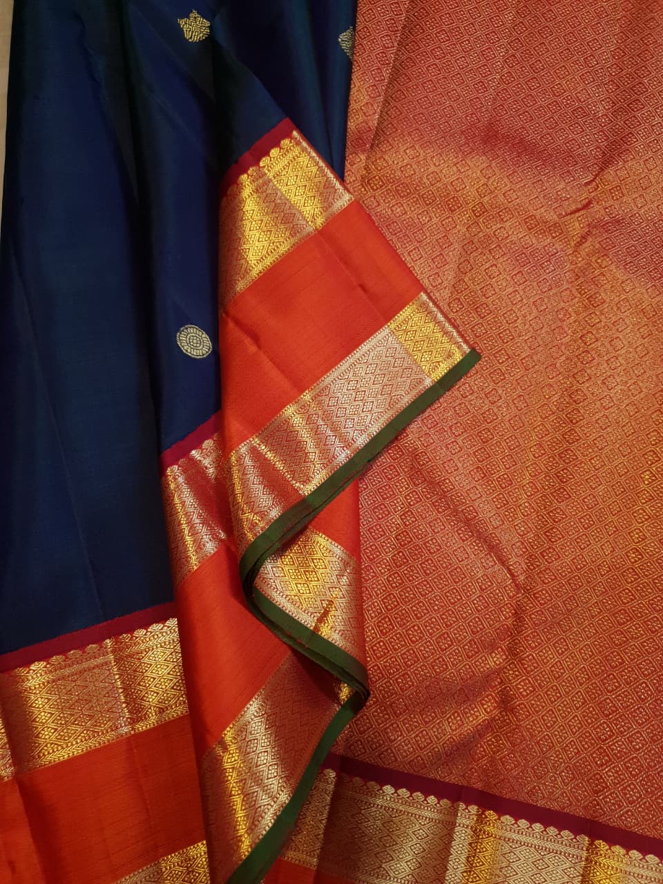 Midnight Blue Kanchipuram Handloom 2G Gold Korvai Silk Saree with contrasting orange gap borders and traditional motifs.