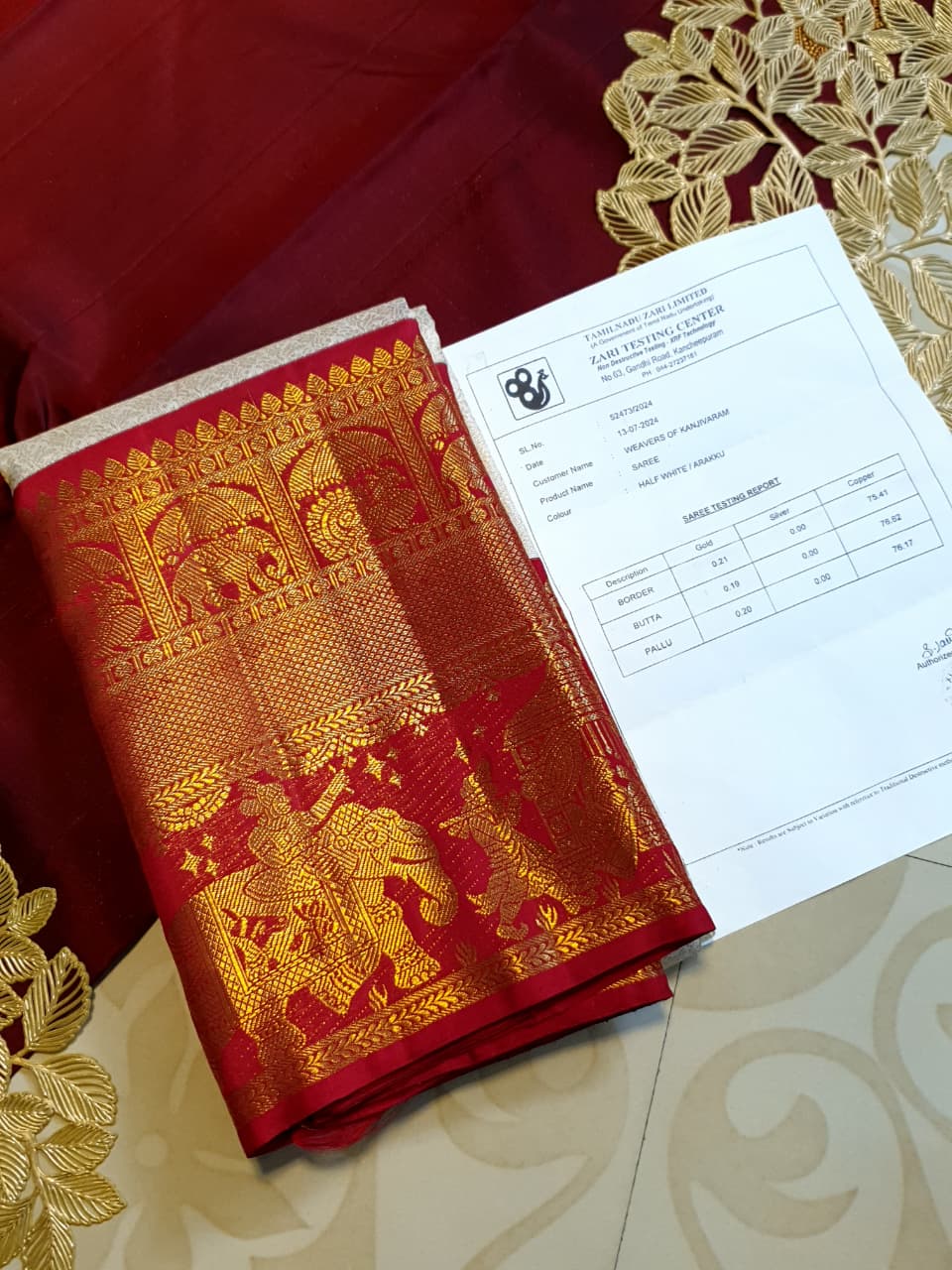 Cream Kanchipuram handloom silk saree with a vibrant pink and gold border, featuring intricate Kalyana Pallakku zari work, accessorized with traditional gold jewelry.