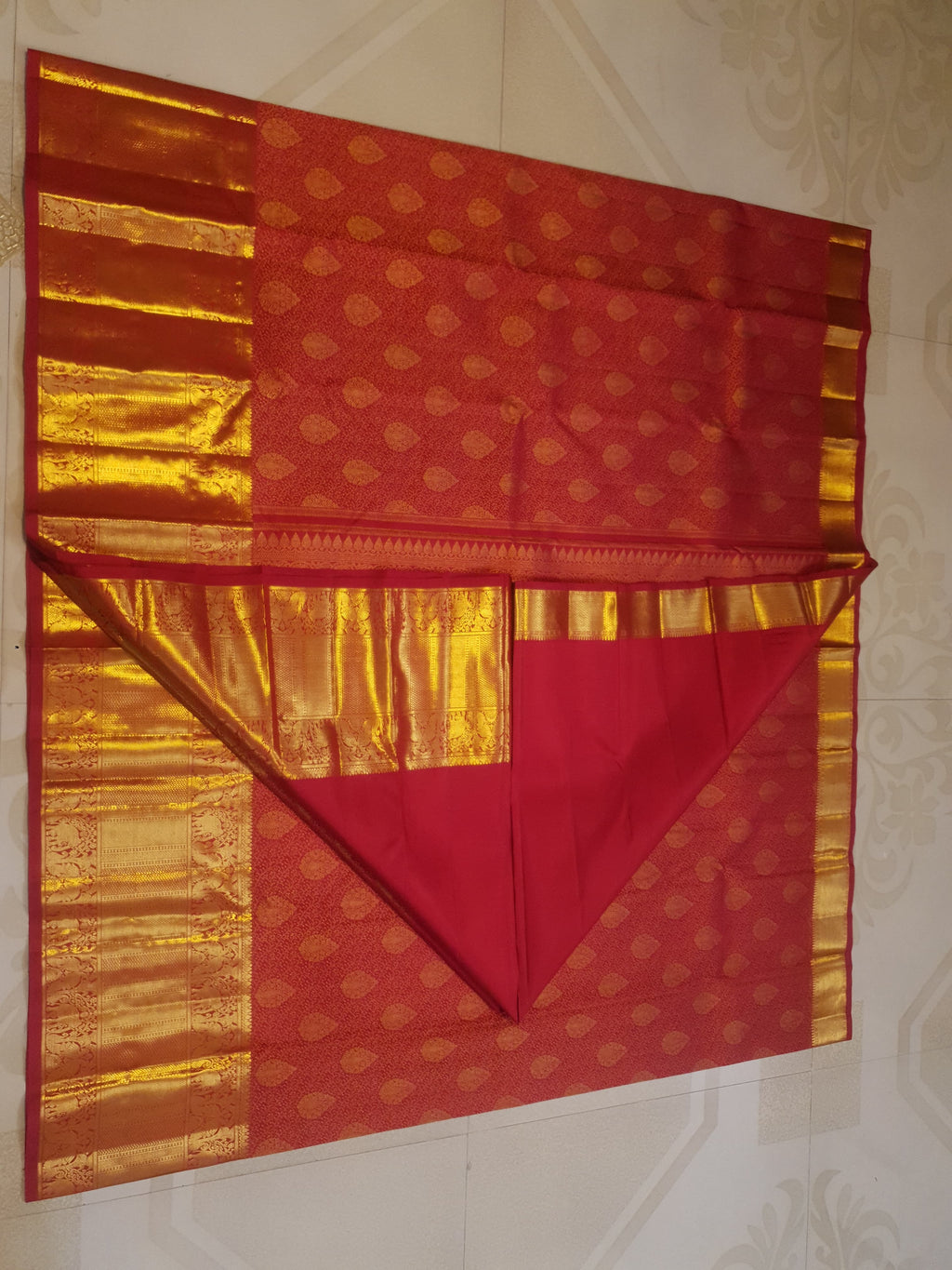 Chilly Red Kanchipuram handloom 2G gold pattu silk saree featuring traditional gold zari weaving and rich elephant and floral motifs.