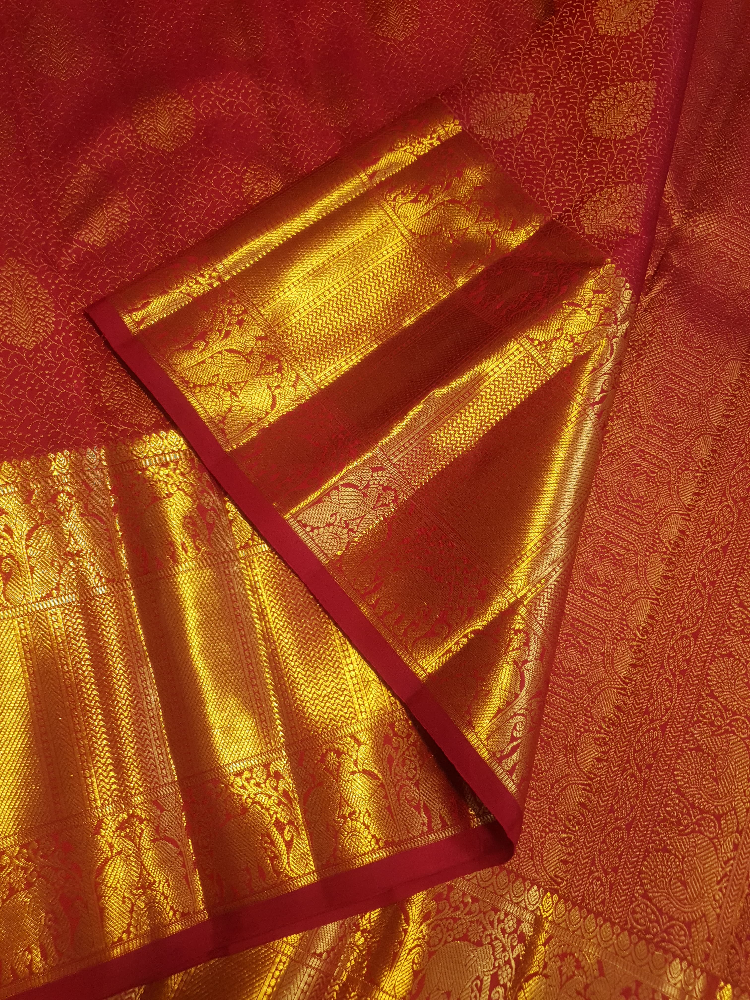 Chilly Red Kanchipuram handloom 2G gold pattu silk saree featuring traditional gold zari weaving and rich elephant and floral motifs.