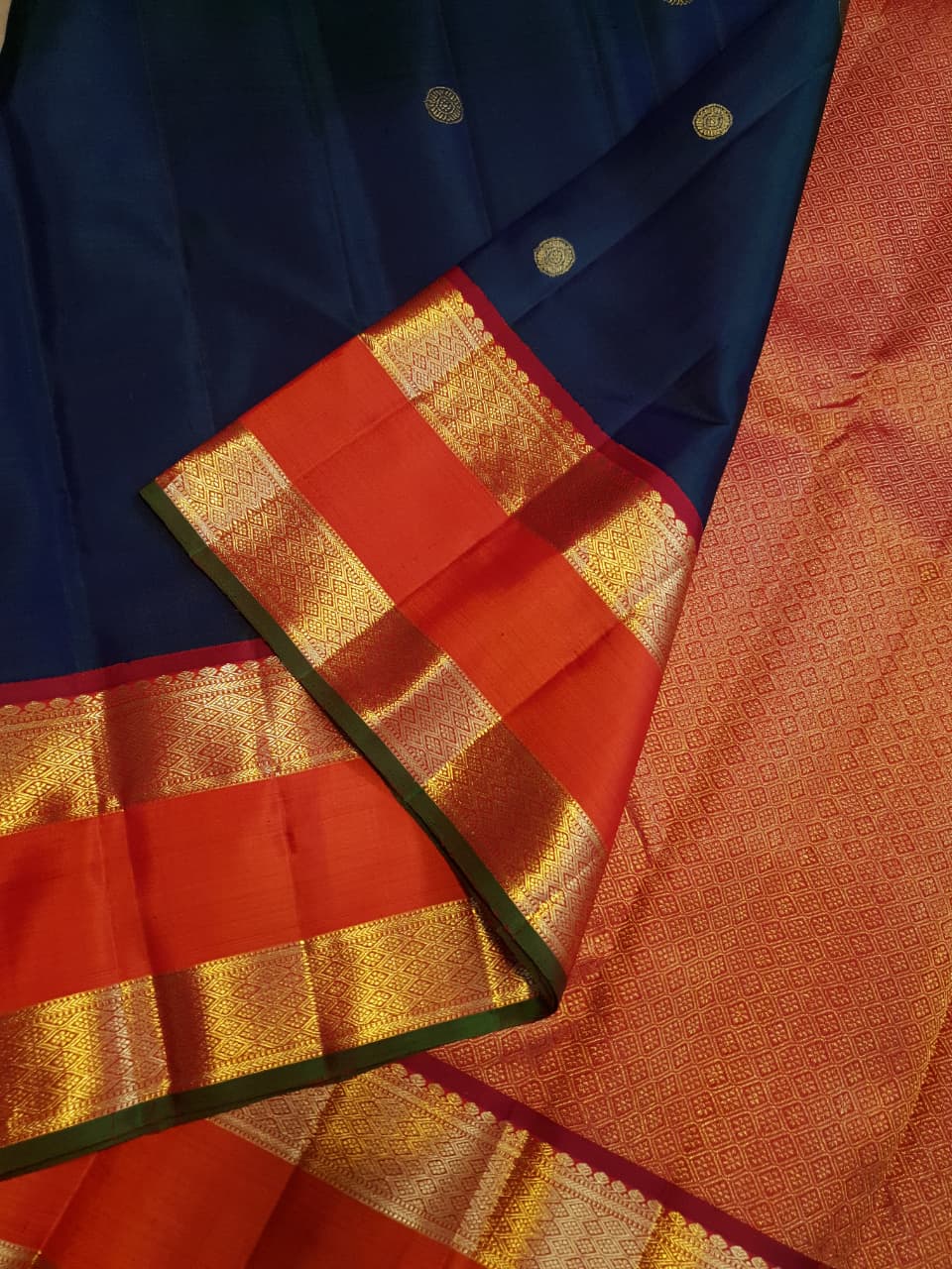 Midnight Blue Kanchipuram Handloom 2G Gold Korvai Silk Saree with contrasting orange gap borders and traditional motifs.