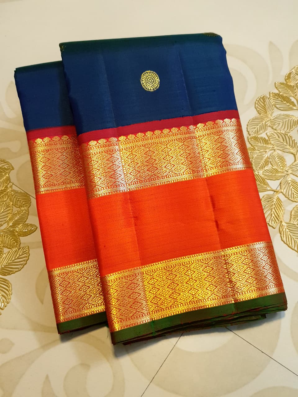 Midnight Blue Kanchipuram Handloom 2G Gold Korvai Silk Saree with contrasting orange gap borders and traditional motifs.