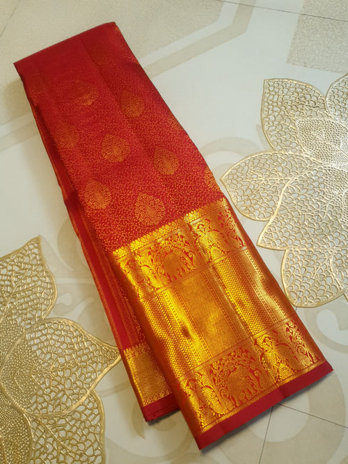 Chilly Red Kanchipuram handloom 2G gold pattu silk saree featuring traditional gold zari weaving and rich elephant and floral motifs.