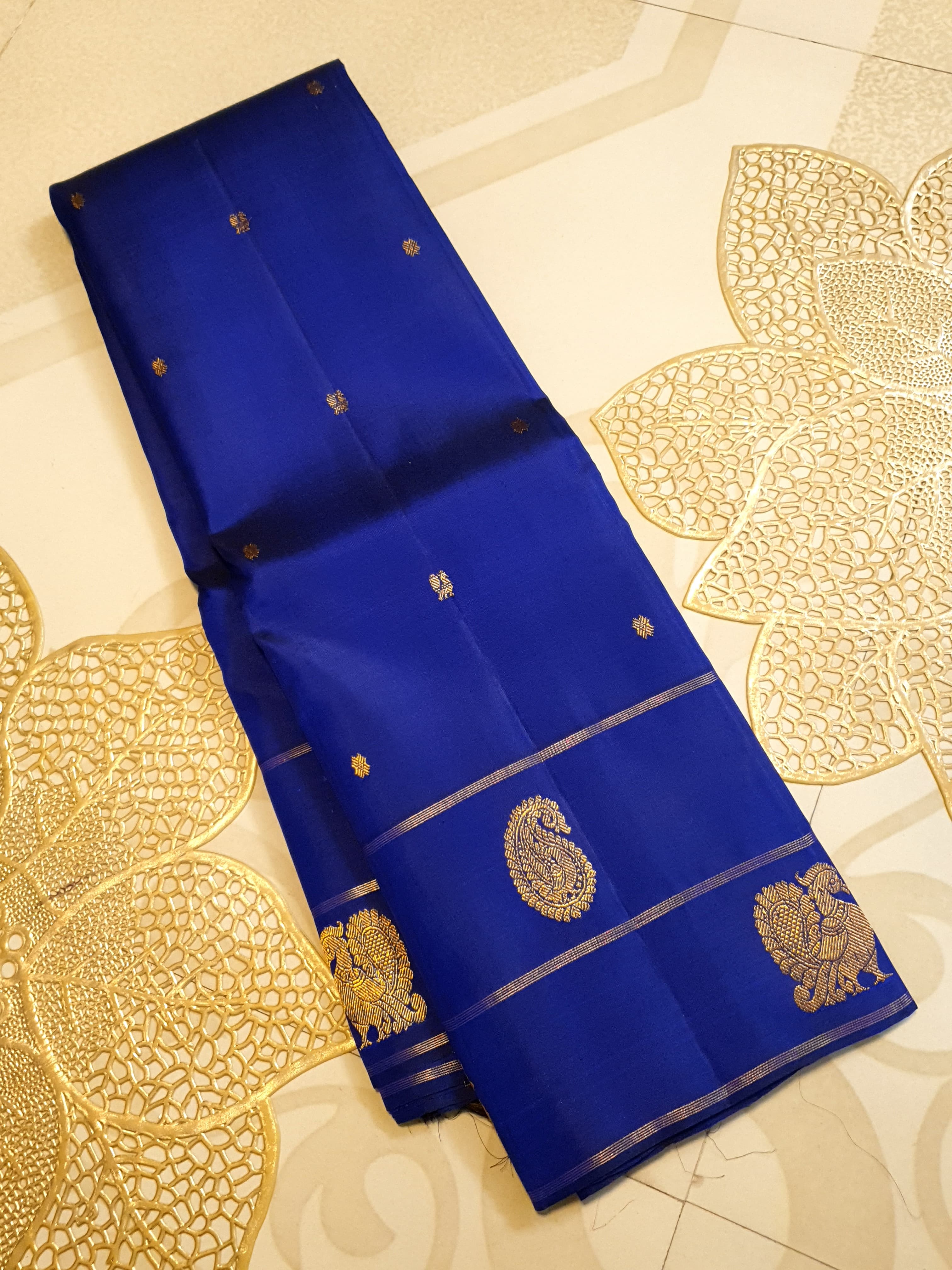 Royal Blue Kanchipuram handloom pattu silk saree featuring intricate 2G gold paisley and peacock motifs, classic gold zari borders, and a certified silk mark weave.