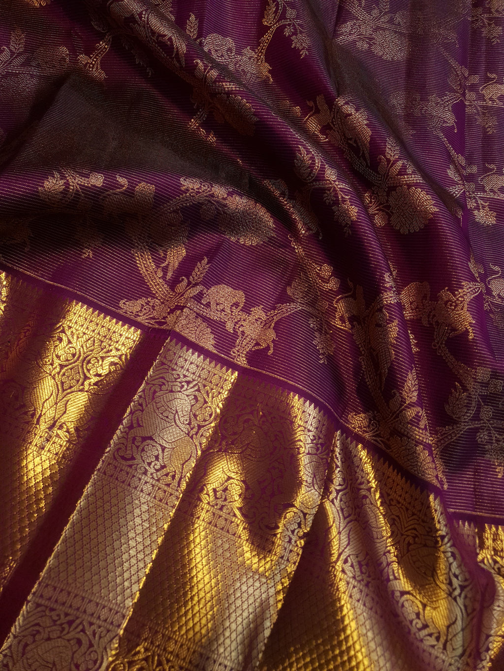 Magenta Kanchipuram handloom silk saree featuring 2G gold vairaoosi stripes, traditional floral motifs, a rich zari border, and Silk Mark certification.