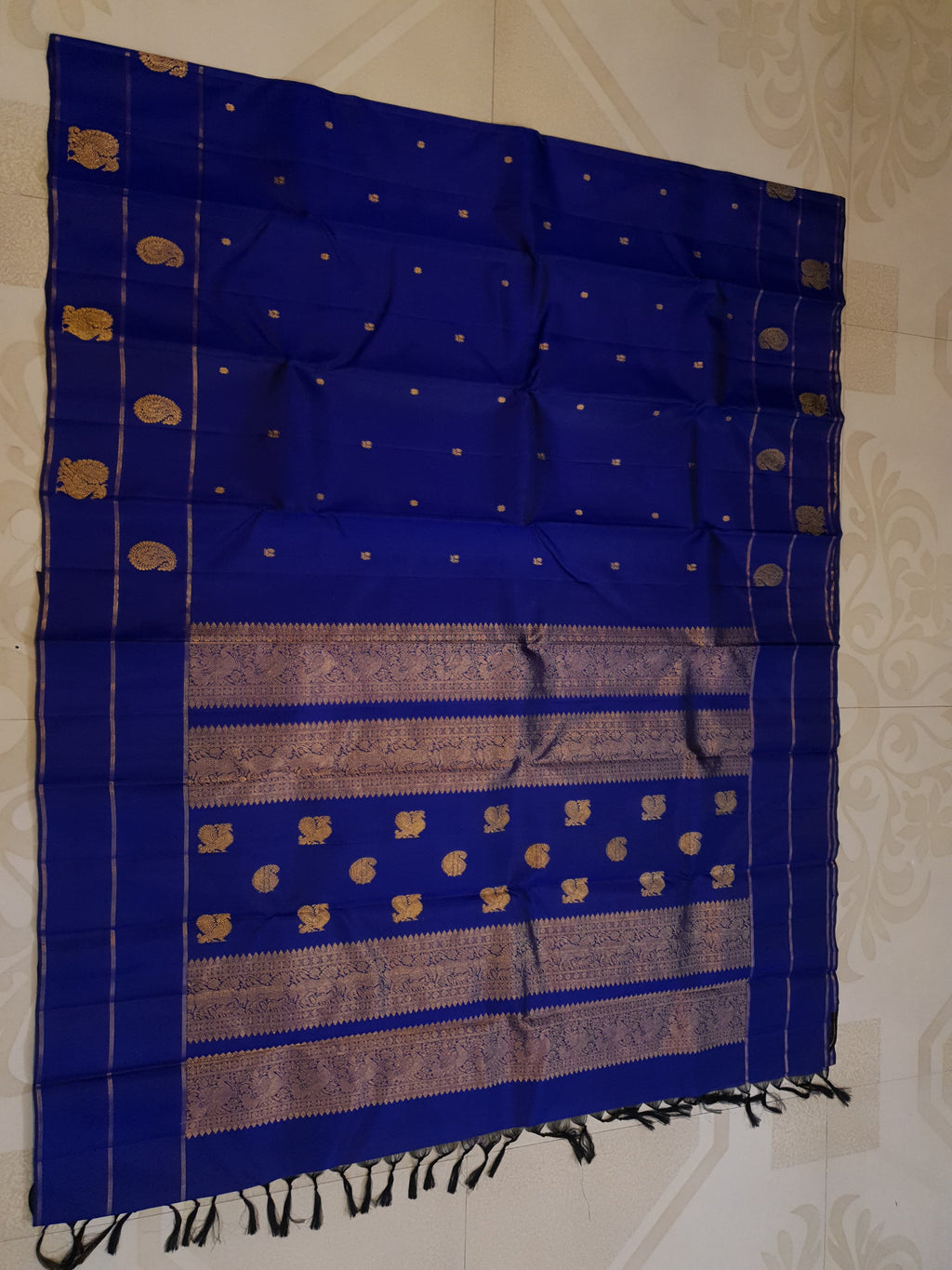 Royal Blue Kanchipuram handloom pattu silk saree featuring intricate 2G gold paisley and peacock motifs, classic gold zari borders, and a certified silk mark weave.