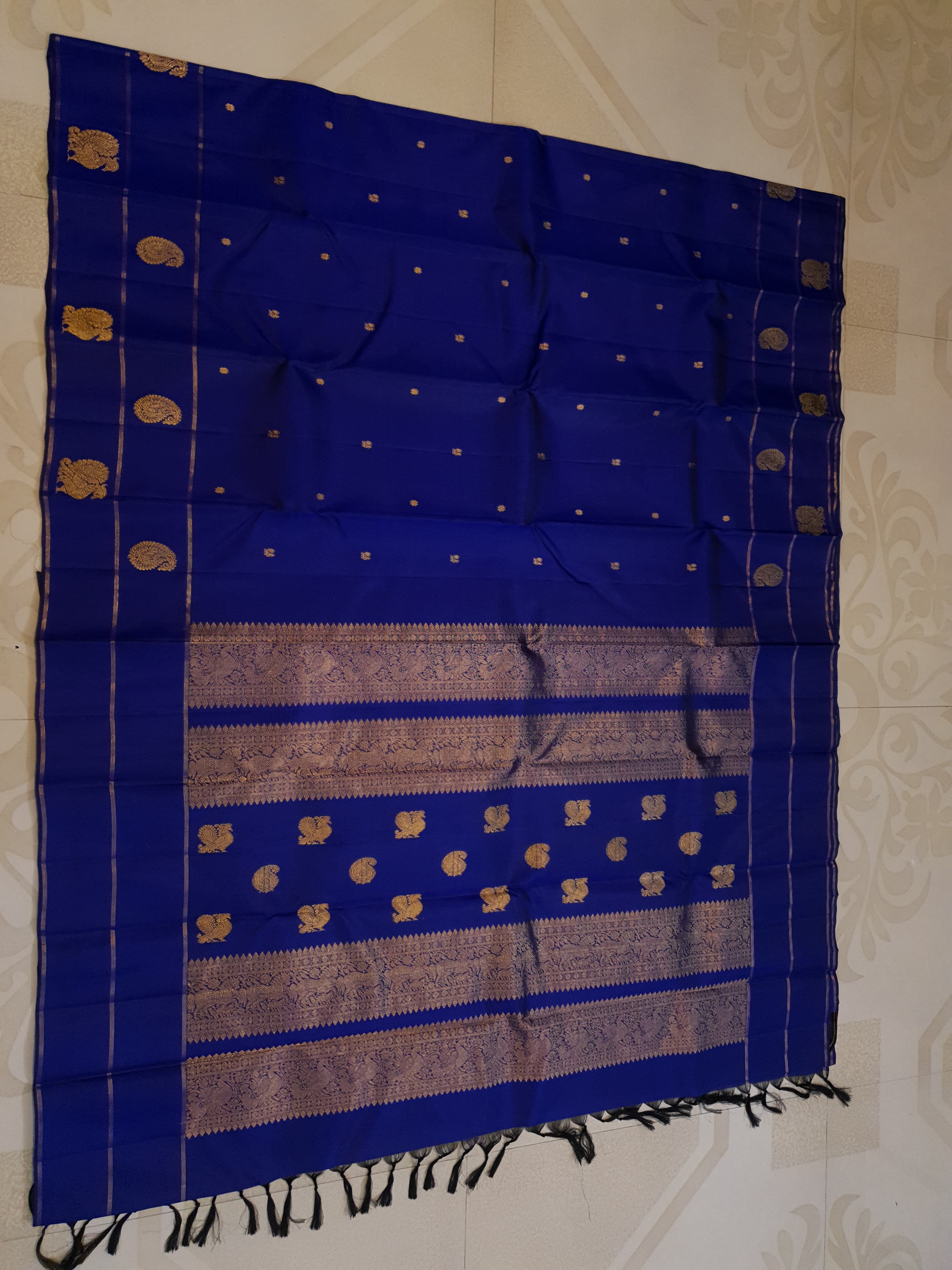 Royal Blue Kanchipuram handloom pattu silk saree featuring intricate 2G gold paisley and peacock motifs, classic gold zari borders, and a certified silk mark weave.