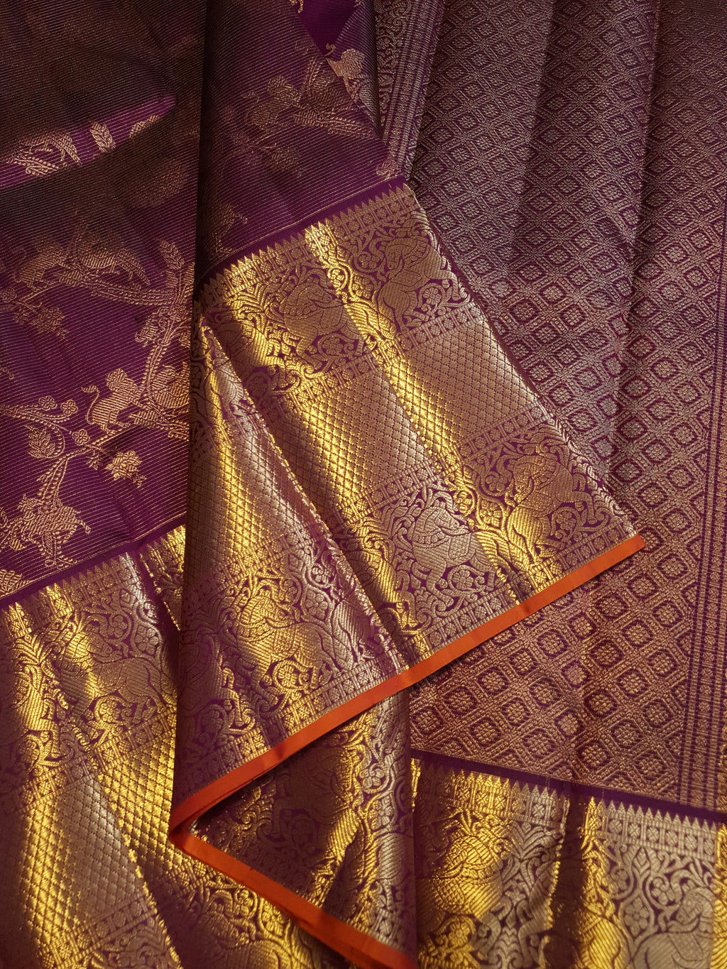 Magenta Kanchipuram handloom silk saree featuring 2G gold vairaoosi stripes, traditional floral motifs, a rich zari border, and Silk Mark certification.