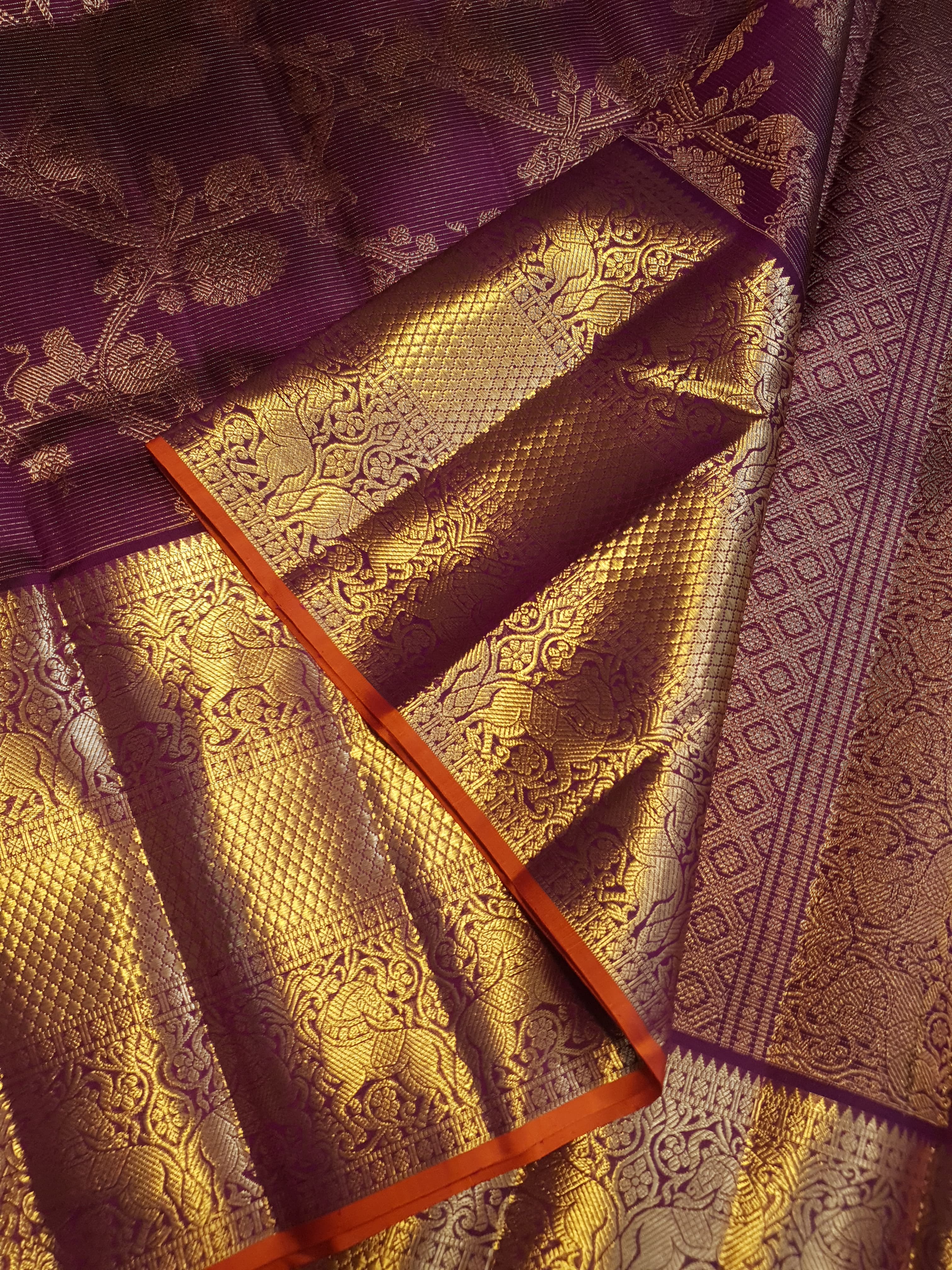 Magenta Kanchipuram handloom silk saree featuring 2G gold vairaoosi stripes, traditional floral motifs, a rich zari border, and Silk Mark certification.
