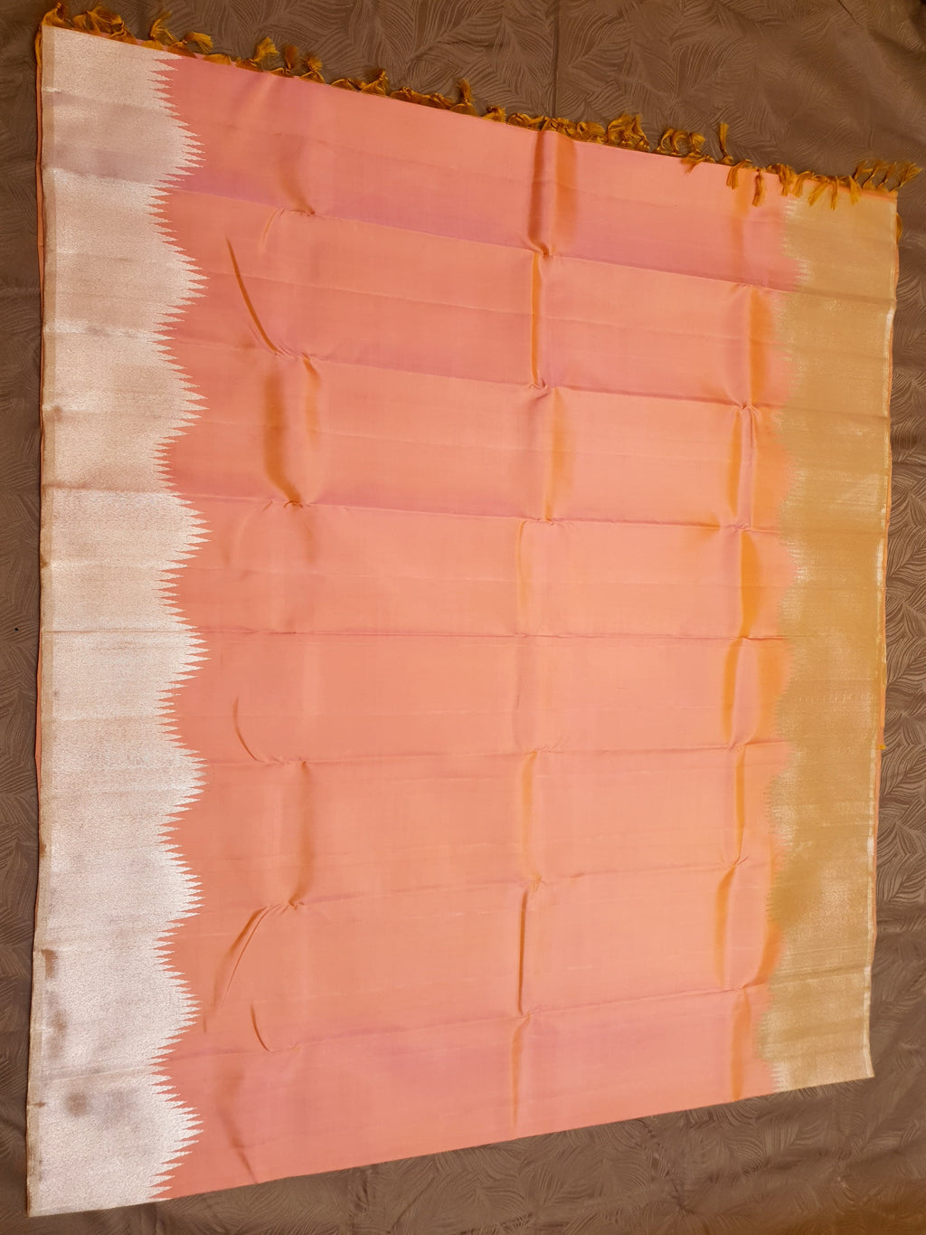 Coral Kanchipuram handloom silk saree featuring a detailed silver zari temple border and luxurious silver accents.