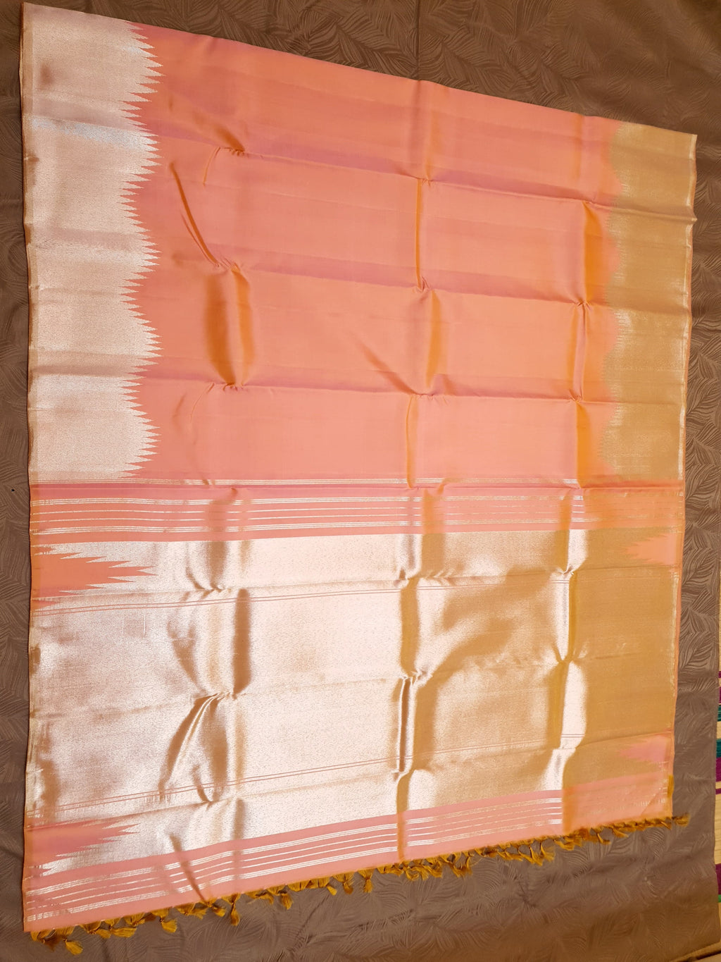 Coral Kanchipuram handloom silk saree featuring a detailed silver zari temple border and luxurious silver accents.