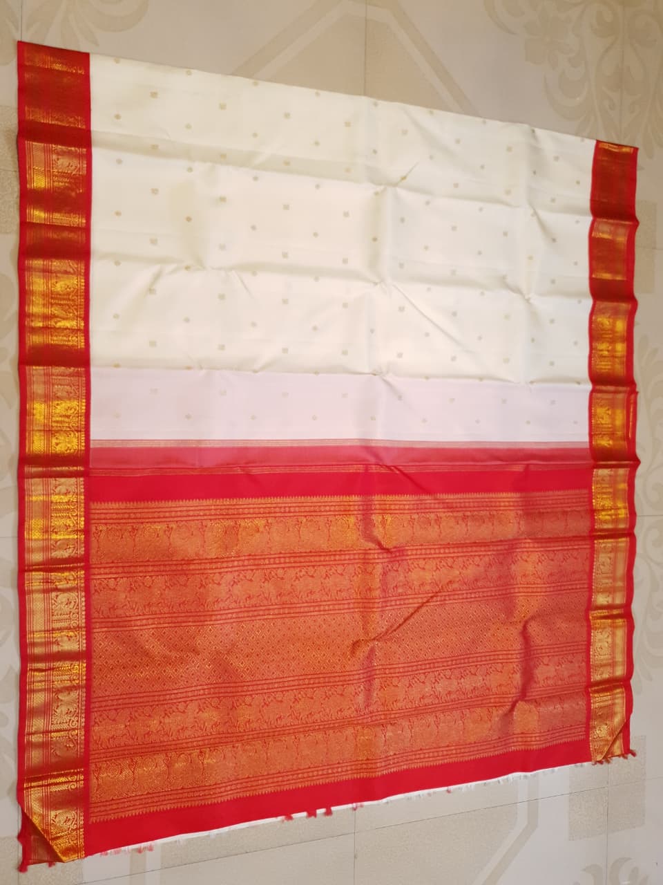 Off White Kanchipuram Handloom Silk Saree featuring Mayil Chakram motifs, contrast red borders, and a matching red pallu and blouse.
