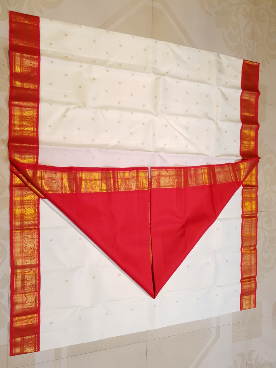 Off White Kanchipuram Handloom Silk Saree featuring Mayil Chakram motifs, contrast red borders, and a matching red pallu and blouse.