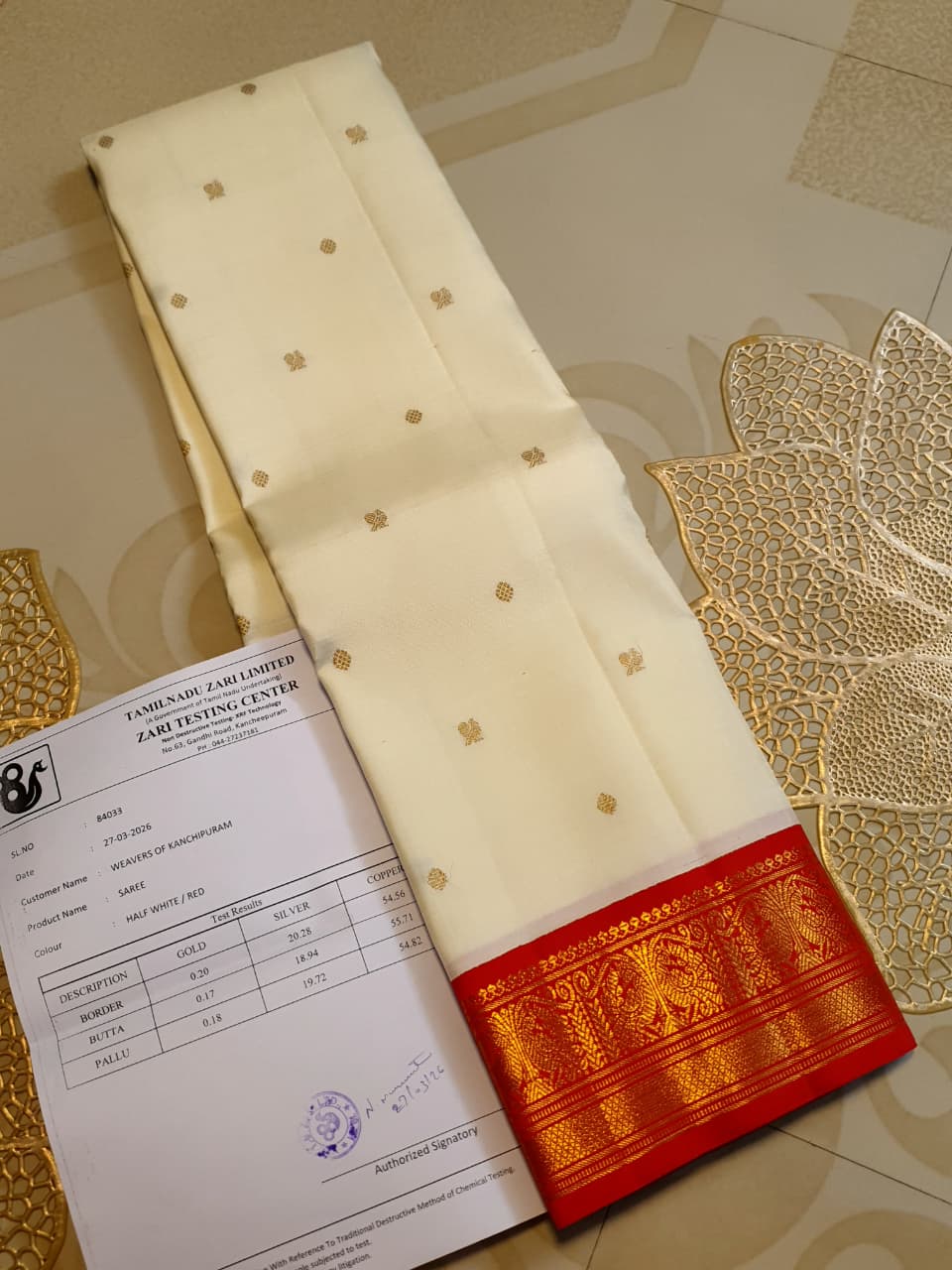 Off White Kanchipuram Handloom Silk Saree featuring Mayil Chakram motifs, contrast red borders, and a matching red pallu and blouse.