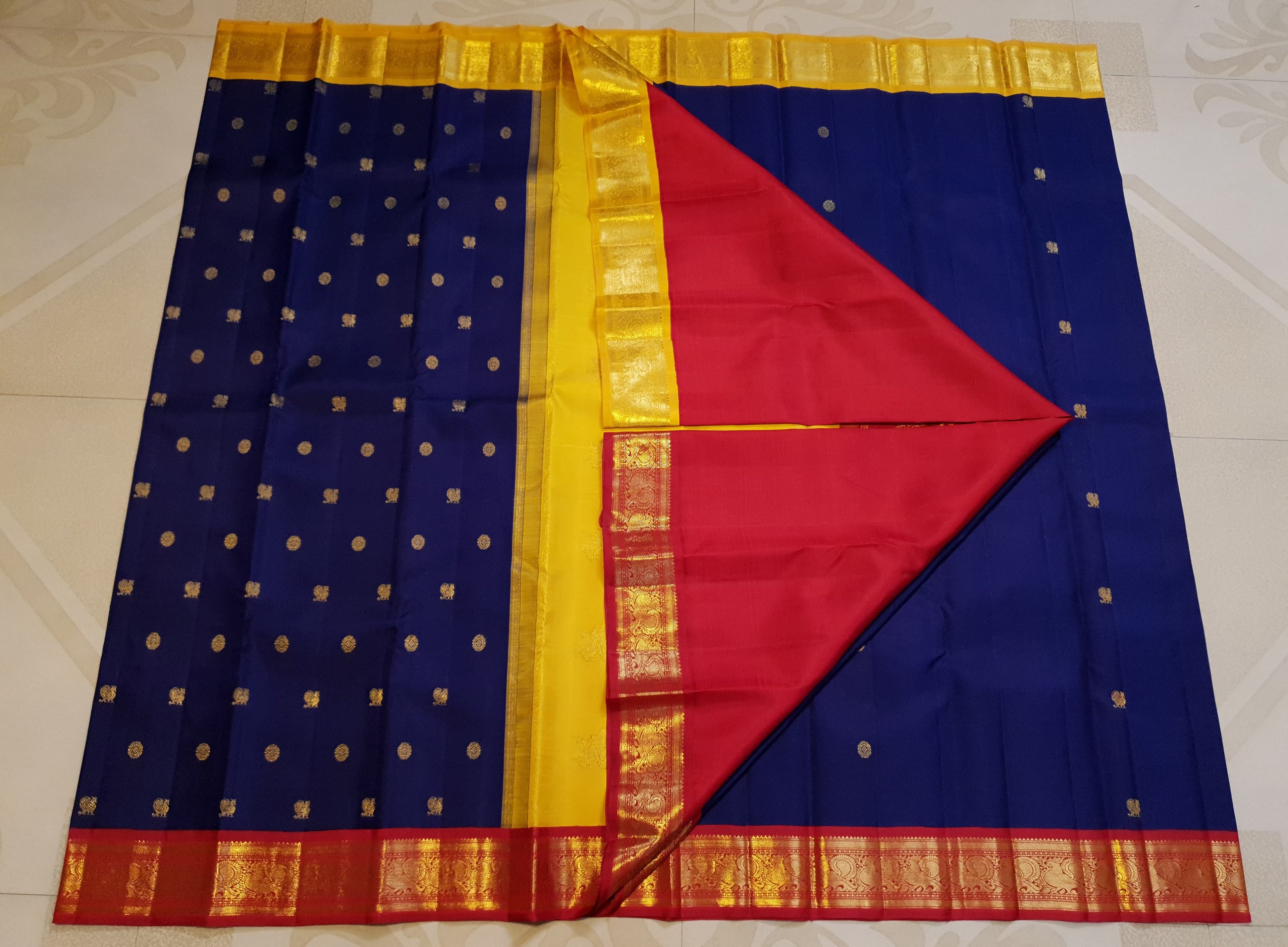 Royal Blue Kanchipuram Handloom 3G Gold Korvai Silk Ganga Jamuna Saree with traditional buttas and dual-color borders.