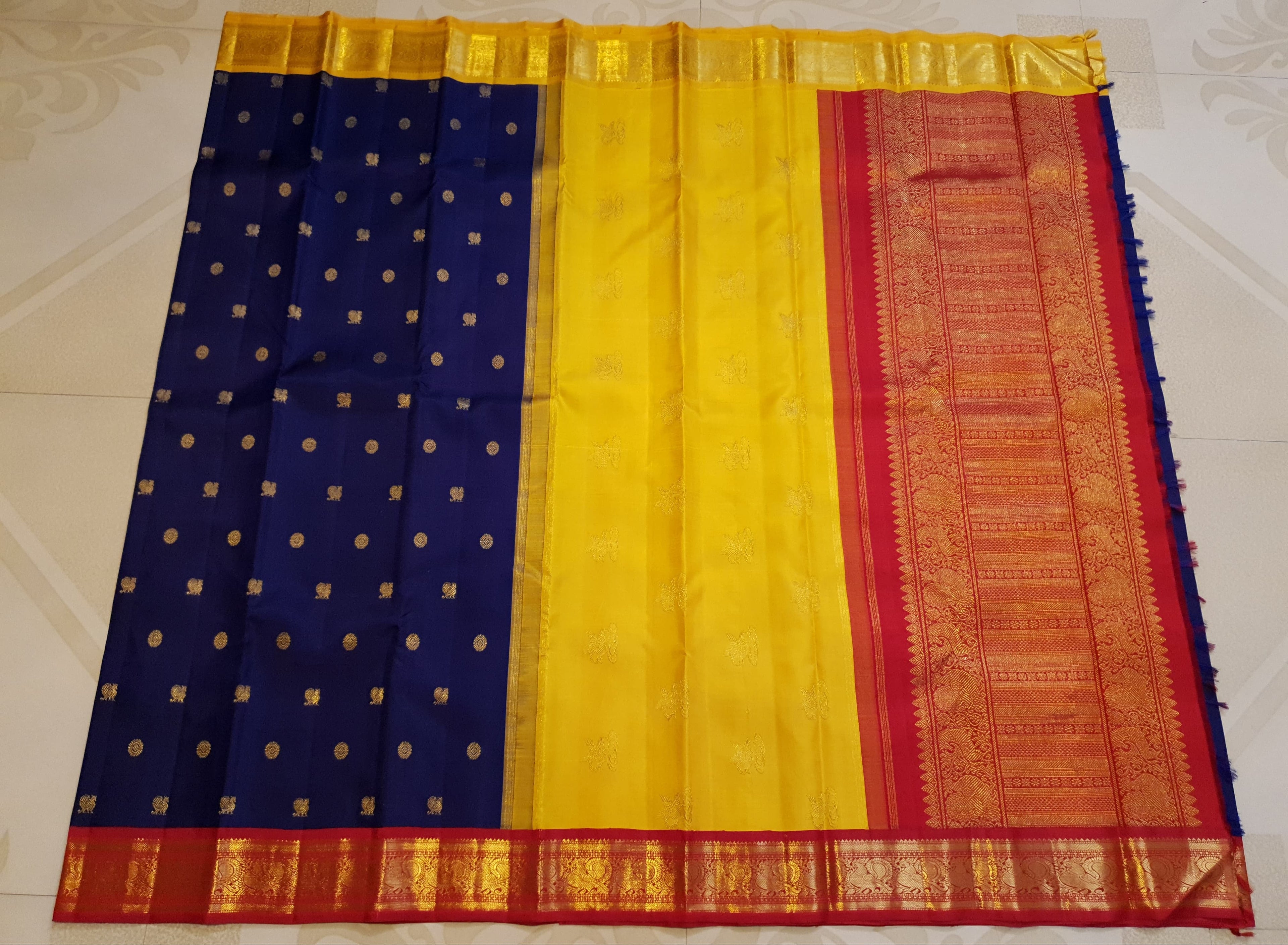 Royal Blue Kanchipuram Handloom 3G Gold Korvai Silk Ganga Jamuna Saree with traditional buttas and dual-color borders.