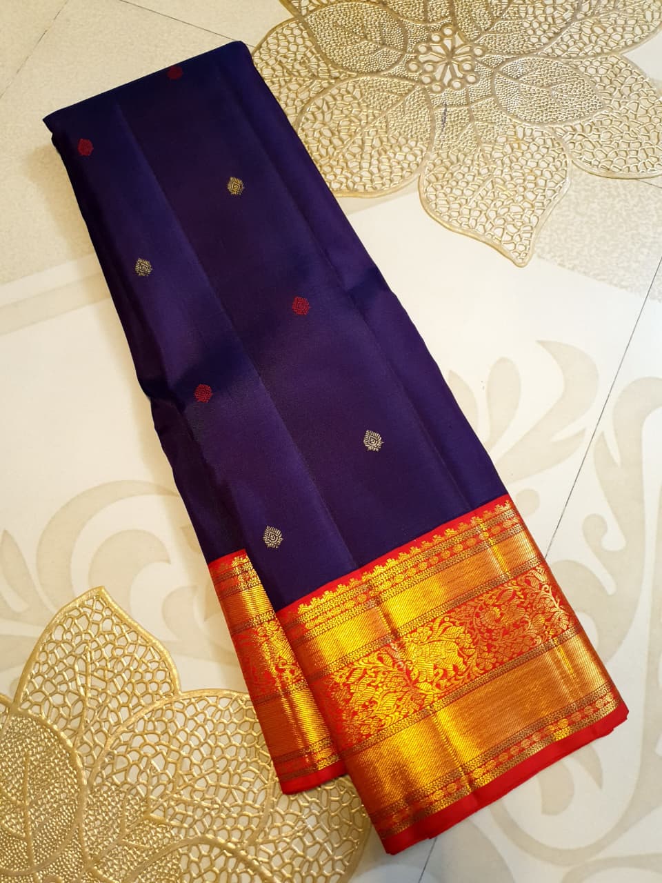 Deep Purple Kanchipuram Handloom Silk Saree with multicolored chakram motifs across the body and a wide red Korvai border featuring intricate gold zari.