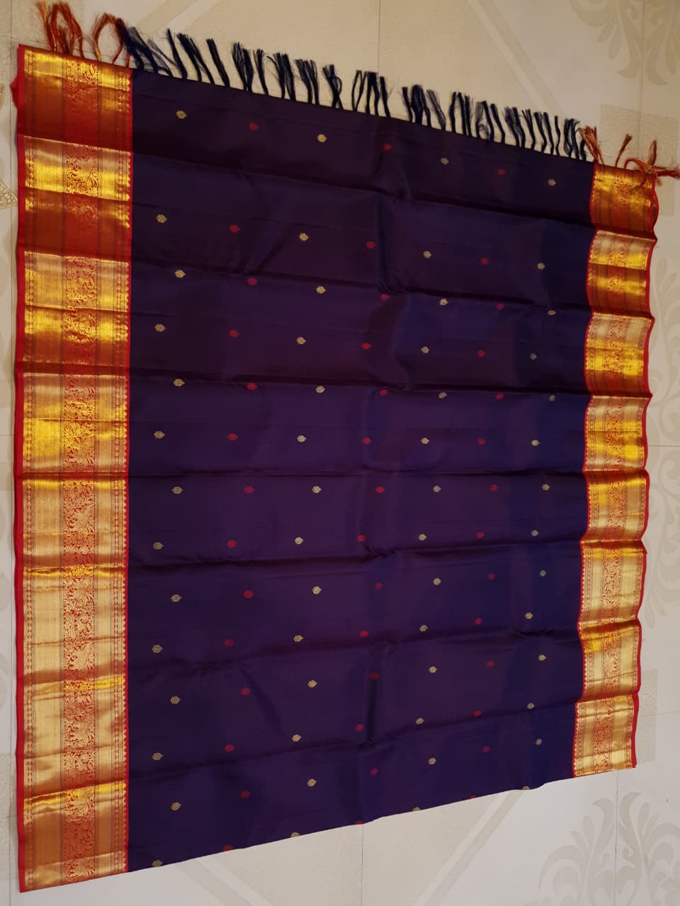 Deep Purple Kanchipuram Handloom Silk Saree with multicolored chakram motifs across the body and a wide red Korvai border featuring intricate gold zari.