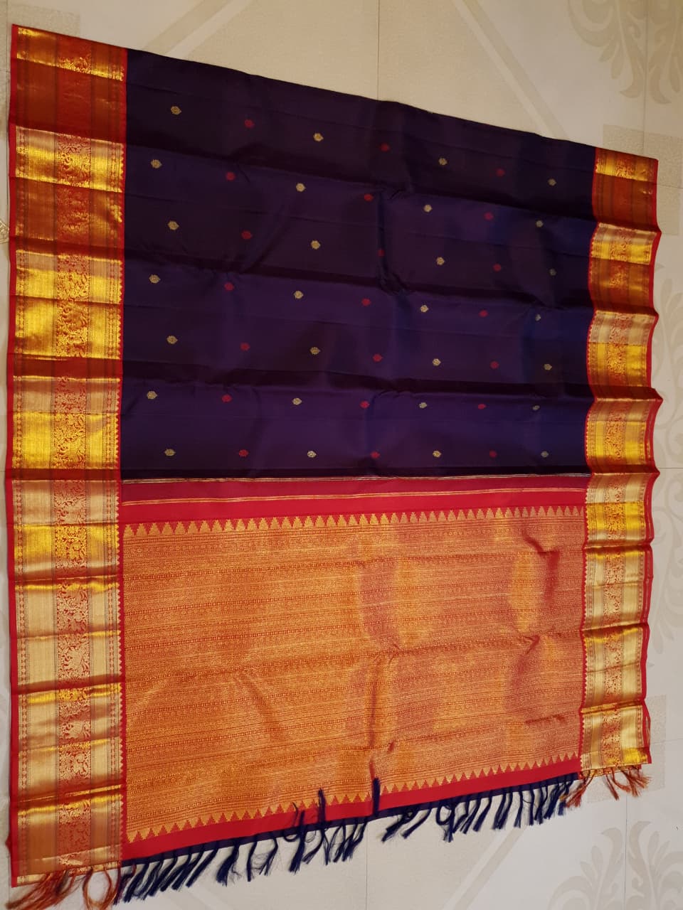 Deep Purple Kanchipuram Handloom Silk Saree with multicolored chakram motifs across the body and a wide red Korvai border featuring intricate gold zari.