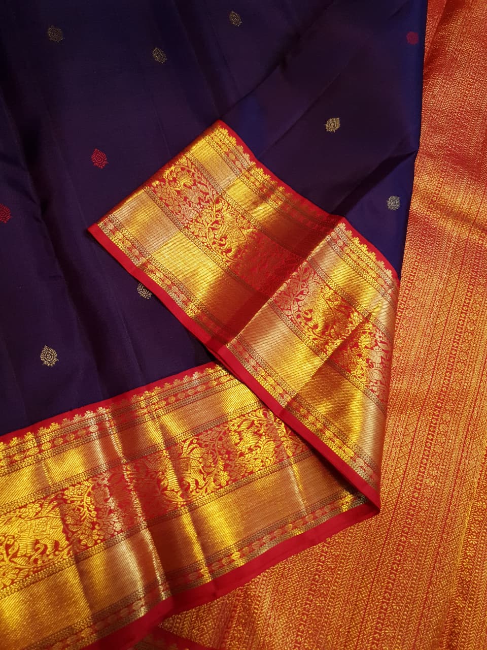 Deep Purple Kanchipuram Handloom Silk Saree with multicolored chakram motifs across the body and a wide red Korvai border featuring intricate gold zari.