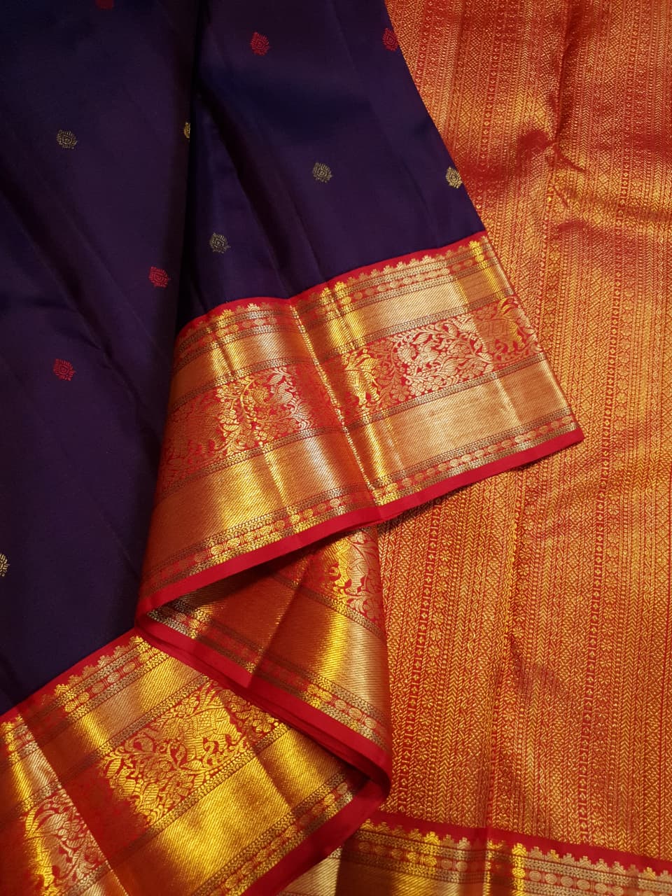 Deep Purple Kanchipuram Handloom Silk Saree with multicolored chakram motifs across the body and a wide red Korvai border featuring intricate gold zari.
