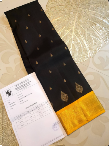 A luxurious black Kanchipuram handloom 4G pure gold pattu silk saree featuring intricate traditional motifs and a lustrous weave.