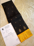 A luxurious black Kanchipuram handloom 4G pure gold pattu silk saree featuring intricate traditional motifs and a lustrous weave.