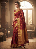 Elegant model wearing a maroon Kanchipuram handloom 2G gold bridal silk saree featuring traditional elephant zari borders and intricate woven buttas.