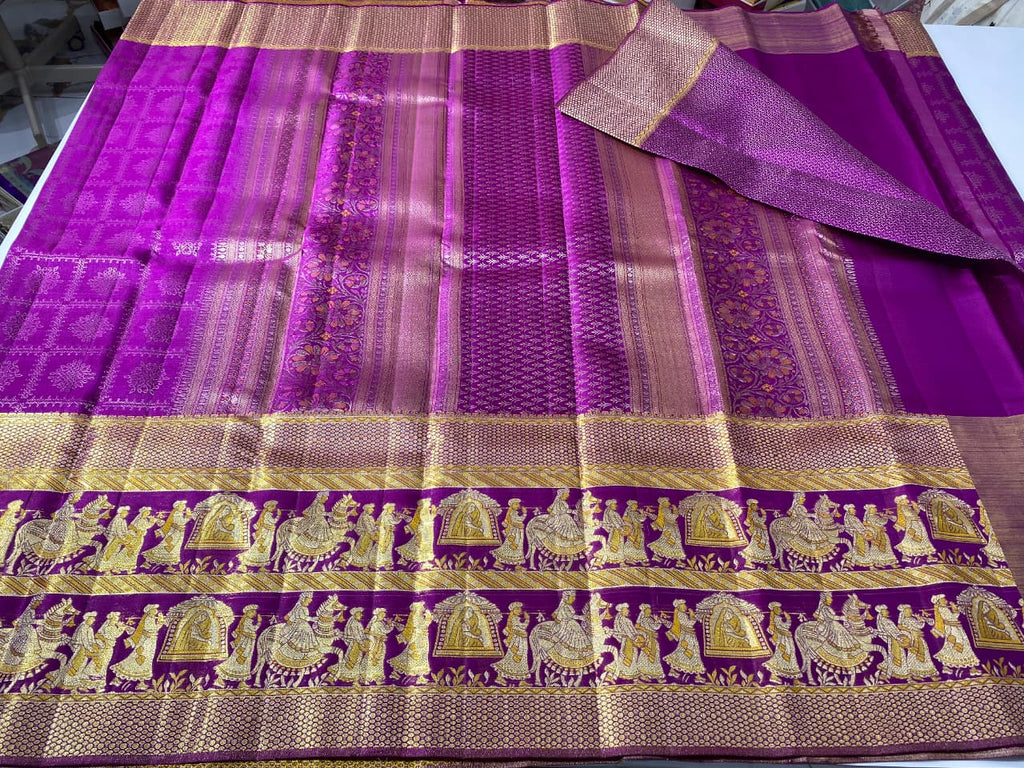 A luxurious purple Kanchipuram handloom tissue silk saree with an ornate gold zari border showcasing detailed Kalyana Pallakku (bridal palanquin) meenakari motifs.