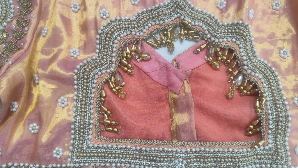 Detailed view of custom Maggham embroidery work on premium pink fabric, showcasing intricate hand-embroidered borders, leaf motifs, and beadwork on a traditional wooden embroidery frame