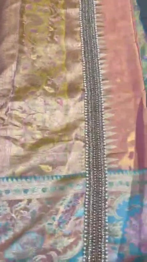 Detailed view of custom Maggham embroidery work on premium pink fabric, showcasing intricate hand-embroidered borders, leaf motifs, and beadwork on a traditional wooden embroidery frame