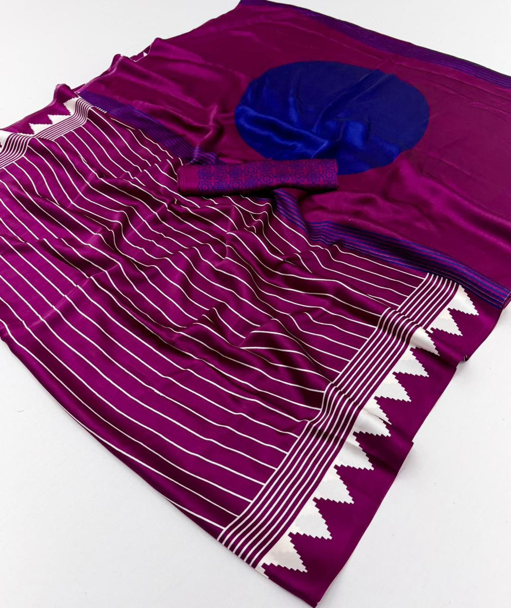 A vibrant magenta modal silk saree with white vertical pinstripes, a large royal blue circular design on the pallu, and a matching patterned blouse piece.