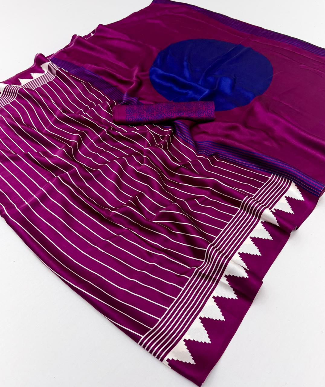 A vibrant magenta modal silk saree with white vertical pinstripes, a large royal blue circular design on the pallu, and a matching patterned blouse piece.