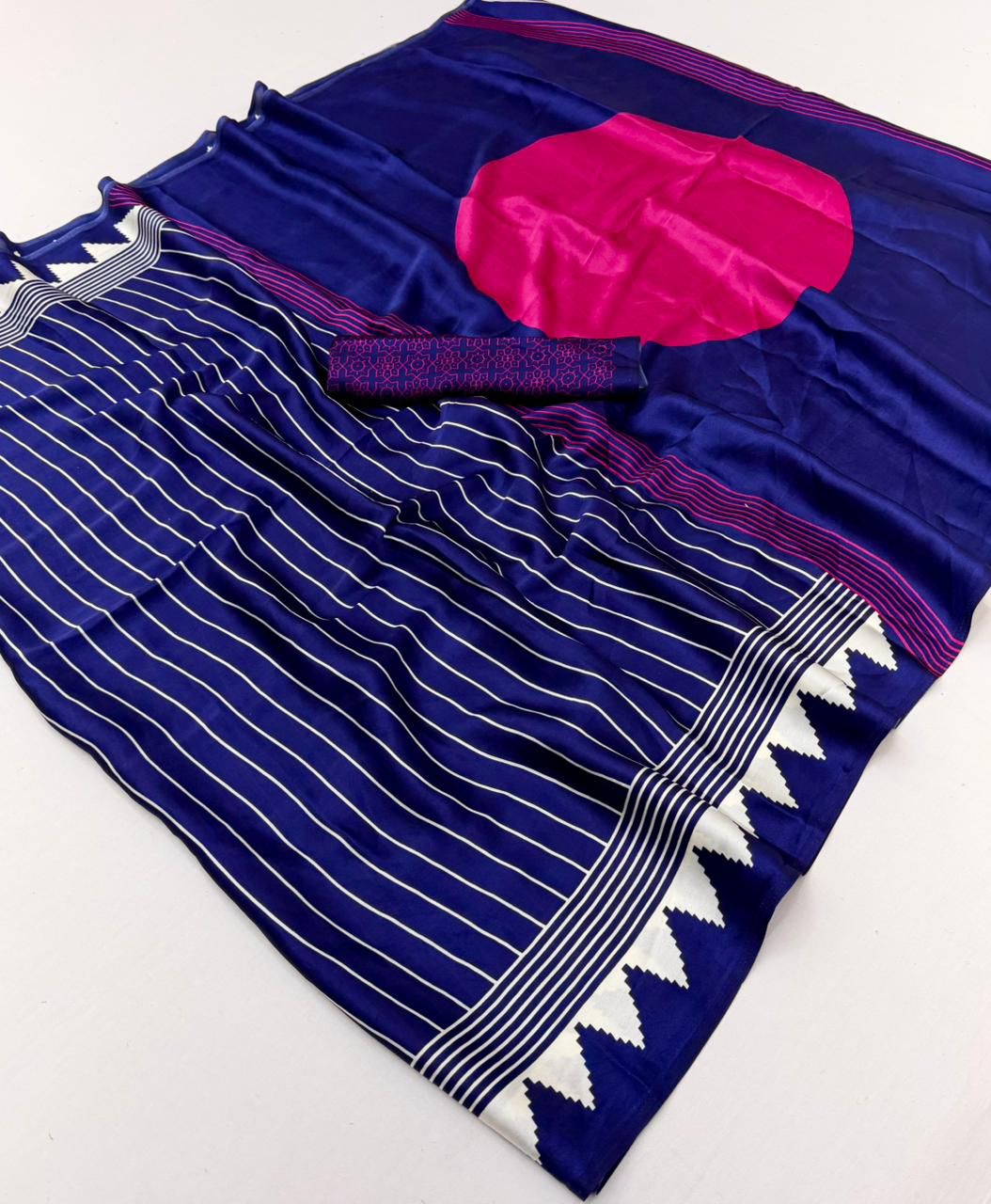 Midnight blue modal silk saree with white vertical pinstripes, a large bright pink circular design on the pallu, and a white sawtooth geometric border.