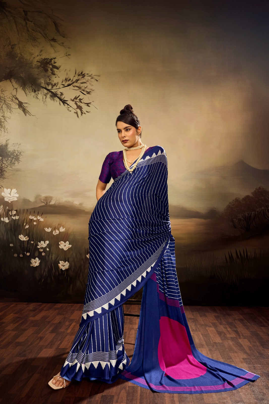 Midnight blue modal silk saree with white vertical pinstripes, a large bright pink circular design on the pallu, and a white sawtooth geometric border.