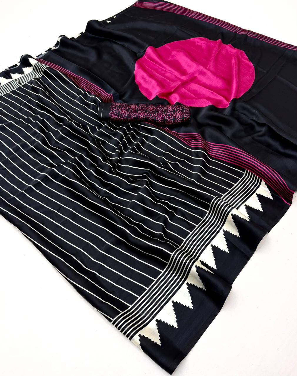 Jet black modal silk saree with white vertical pinstripes, a large bright pink circular motif on the pallu, and a matching patterned blouse piece.
