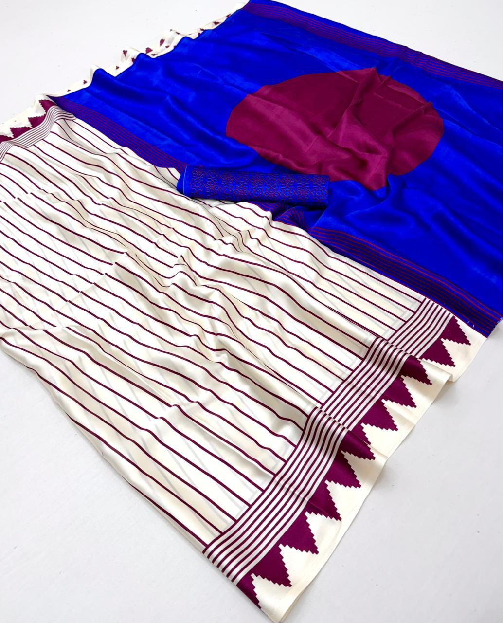 Off-white modal silk saree featuring thin maroon pinstripes, a vibrant electric blue pallu with a large maroon circle, and a maroon sawtooth geometric border.