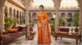 Orange Paithani Handloom Pure Silk Saree with subtle self-woven buttas on the body and a rich tissue zari pallu featuring rows of traditional peacock motifs.