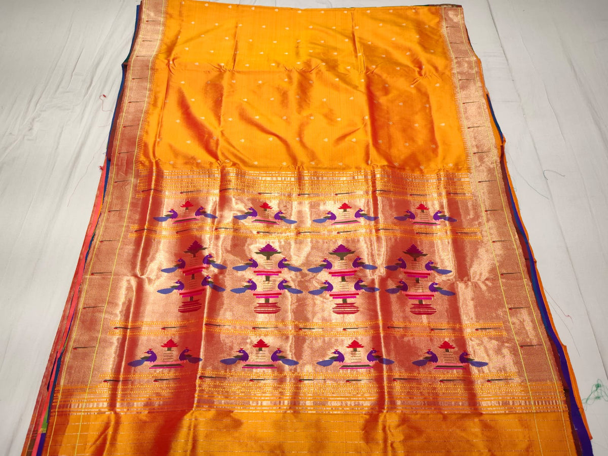 Orange Paithani Handloom Pure Silk Saree with subtle self-woven buttas on the body and a rich tissue zari pallu featuring rows of traditional peacock motifs.