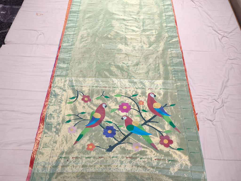 Pista Green Paithani Handloom Pure Silk Saree featuring subtle self-woven buttas on the body and a tissue zari pallu adorned with colorful parrots perched on flowering branches.