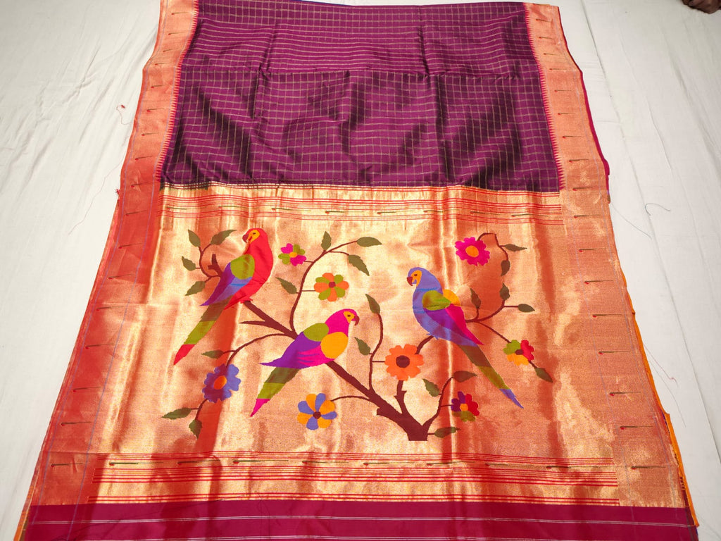 Magenta Paithani Handloom Pure Silk Saree with subtle self check pattern on the body and a tissue zari Munia (Parrot) pallu featuring colourful birds perched on flowering branches.