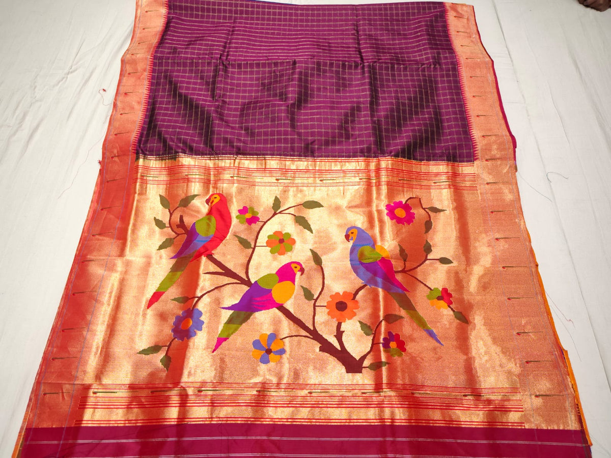 Magenta Paithani Handloom Pure Silk Saree with subtle self check pattern on the body and a tissue zari Munia (Parrot) pallu featuring colourful birds perched on flowering branches.