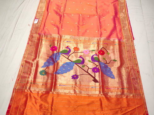 Coral Orange Paithani Handloom Pure Silk Saree featuring delicate self buttas on the body and a tissue zari pallu with colorful peacocks perched on flowering branches.
