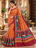 Vibrant orange Patan Patola pure mulberry silk saree featuring a complex double ikat wave and scale pattern with contrasting maroon pallu and border depicting traditional animal and tree motifs.