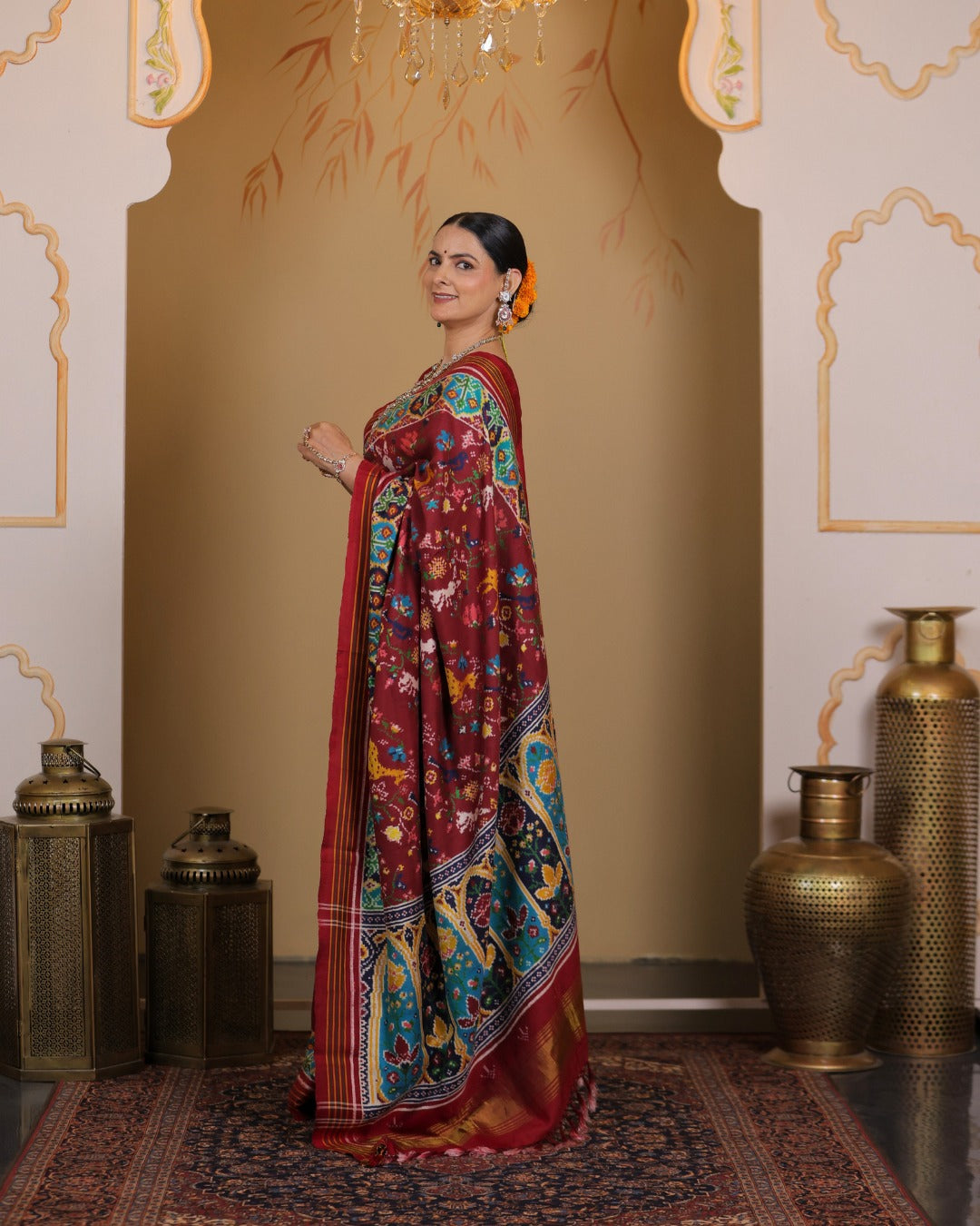 Maroon Patan Patola pure mulberry silk saree featuring a vegetable-dyed jungle design with intricate double ikat weaving and ornate architectural border motifs.