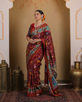 Maroon Patan Patola pure mulberry silk saree featuring a vegetable-dyed jungle design with intricate double ikat weaving and ornate architectural border motifs.